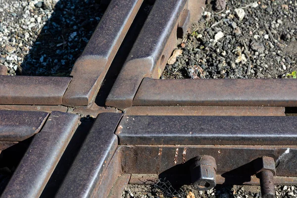Close up for junction of railway rails on the tracks. Photo taken during the day with good lighting