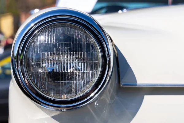 ホワイトクラシックカーのラウンドヘッドライトのクローズアップ 歴史的な車両の美しく復元されたクロムの詳細 — ストック写真