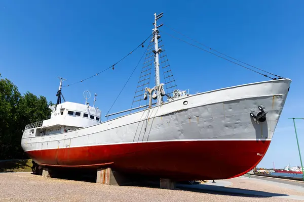 stock image A historic fishing boat pulled out of the water and displayed on the museum's quay. Shot taken on a sunny day, the ship against the blue sky