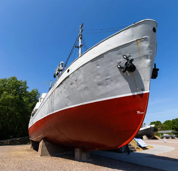 stock image A historic fishing boat pulled out of the water and displayed on the museum's quay. Shot taken on a sunny day, the ship against the blue sky