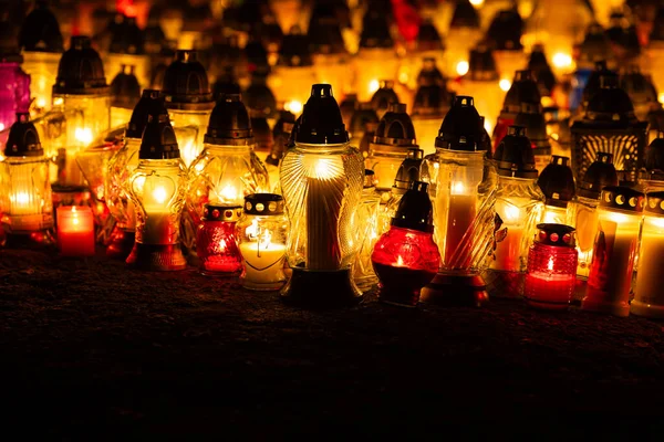 Lots of glass candles burning in the cemetery. A night shot of cemetery candles during All Saints\' Day on November 1.