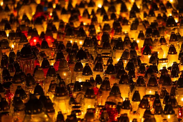 Lots of glass candles burning in the cemetery. A night shot of cemetery candles during All Saints\' Day on November 1.