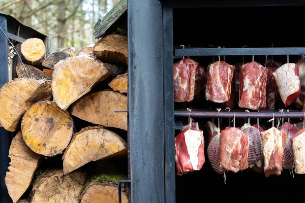 Ecological smoking of pork meat in a home wood-fired smokehouse. Healthy, unprocessed food produced independently.