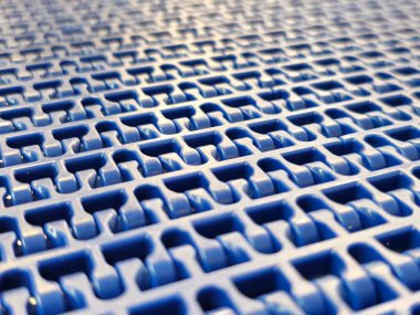 A close-up of a blue polyurethane belt in modular industrial conveyor system. Transport systems in industrial factories. clipart