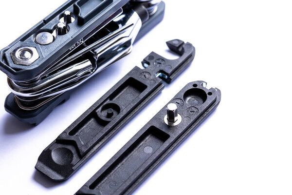 Black bicycle multifunctional multitool unfolded on a white background. Chrome steel tools. Tools for bicycle self-repairing .