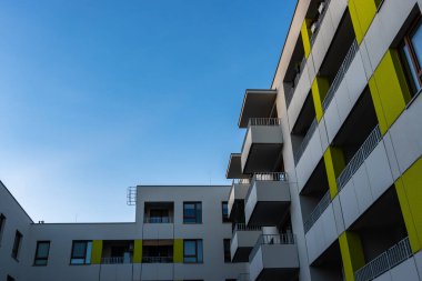 Mavi gökyüzüne karşı modern apartman blokları. Fotoğraflar öğleden sonra ışıklarıyla çekildi.