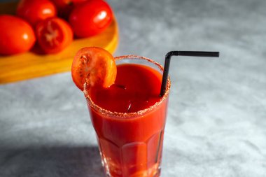 Bloody Mary cocktail in glass served with tomato slice on grey stoned surface. Red cocktail. Alternative taste. Dirty dump drink clipart