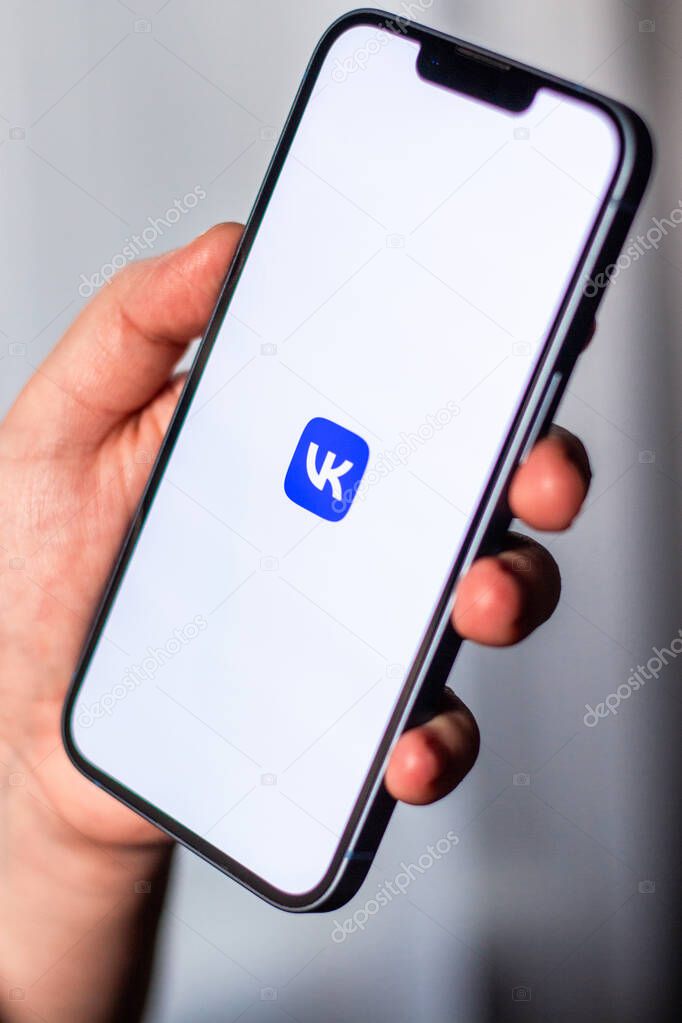 Kaliningrad, Russia 14.01.25 - Woman holding smartphone with VKONTAKTE application on screen. VK social media app.