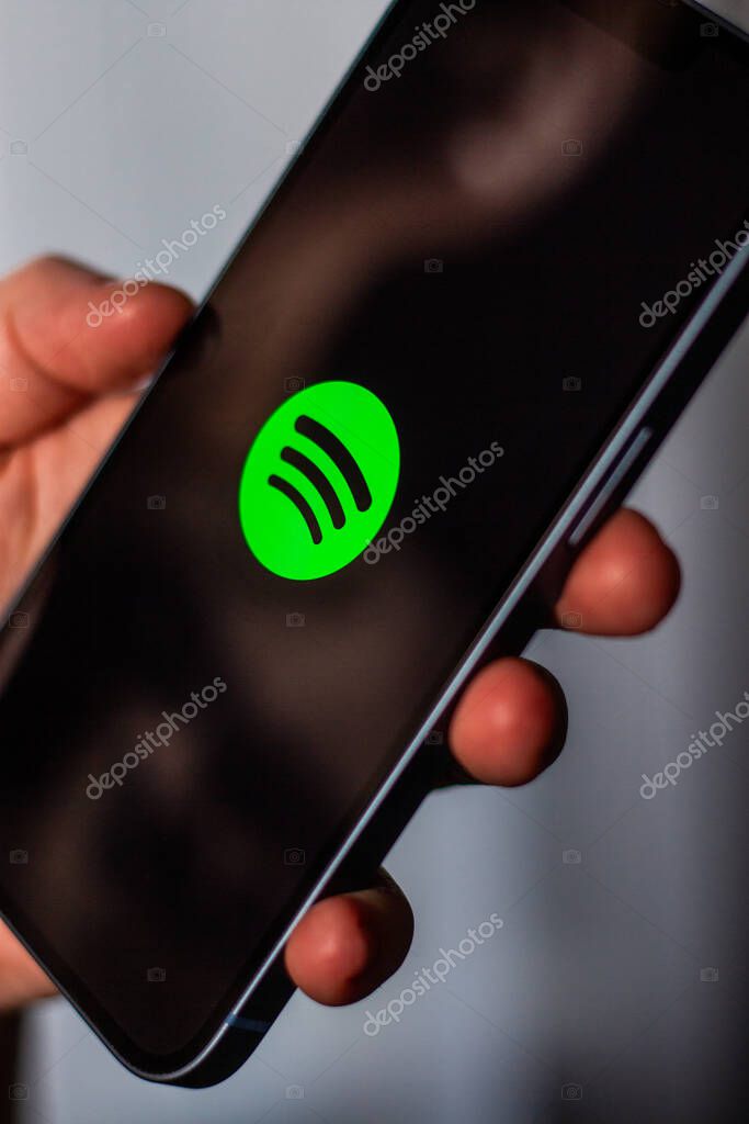 Kaliningrad, Russia 14.01.25 - Woman holding smartphone with SPOTIFY application on screen. Online music app.