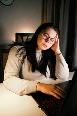Akşam geç saatlerde ev ofisinde bilgisayar başında çalışan bir kadın. İşle ilgili sorunları çözmeye çalışan konsantre kadın bir serbest yazar. Çalışmaktan ve yorgunluktan acı çekmekten