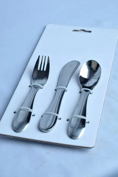 forks spoons and knives eating utensils are neatly arranged in a paper board panel packaging
