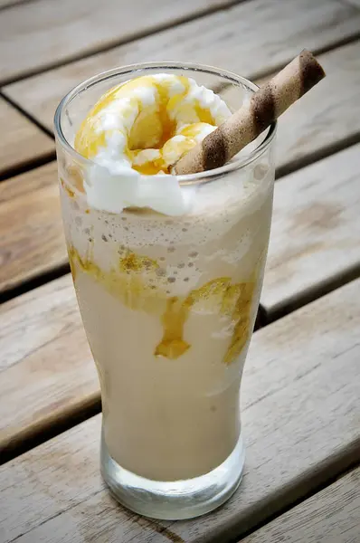 Caramel Choco Float Drink in a glass container placed on the table