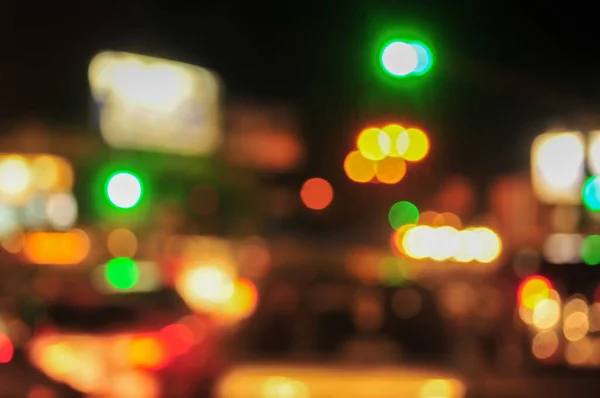 dim city lights blur at night as background