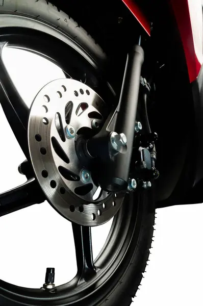 a front wheel disc brake of red scooter type motorbike. 125 cc engine, automatic transmission and fuel injection. Isolated