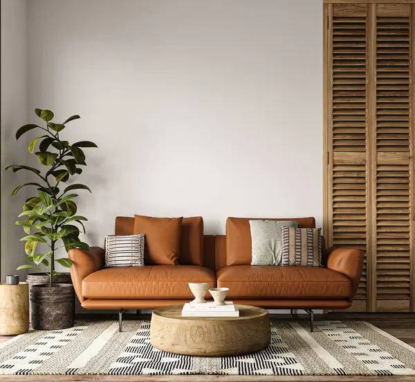 A welcoming living room space adorned with a rich caramel leather sofa, patterned rug, and wooden accents, creating a warm and stylish interior