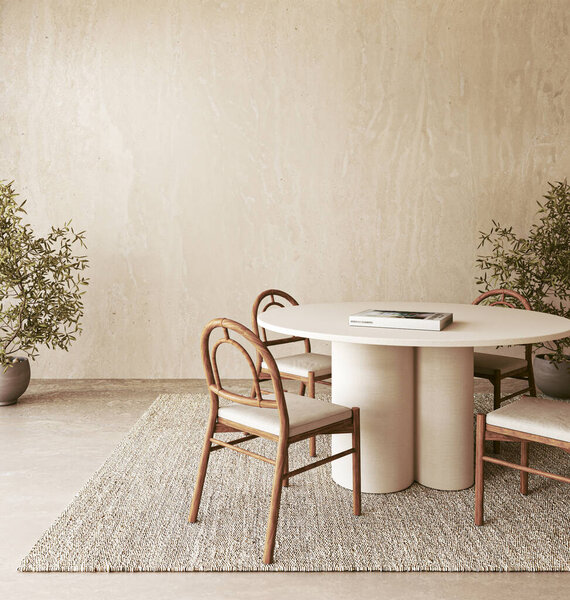 This stylish dining area showcases a round table and natural decor elements, all set within a very serene environment