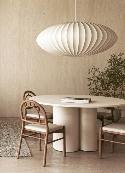 A stylish and minimalist dining area showcasing a beautifully round table paired with a chic pendant lamp above it