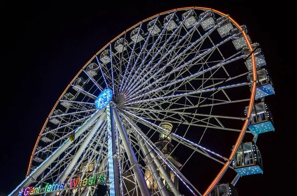 Ferris wheel on Kontraktova Square at the evening during Christmas holidays. Kyiv, Ukraine