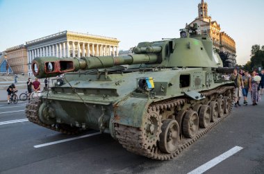 People walk past destroyed russian military equipment and take pictures on Khreshchatyk Street in the center of Kyiv, the capital of Ukraine