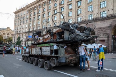 People walk past destroyed russian military equipment and take pictures on Khreshchatyk Street in the center of Kyiv, the capital of Ukraine