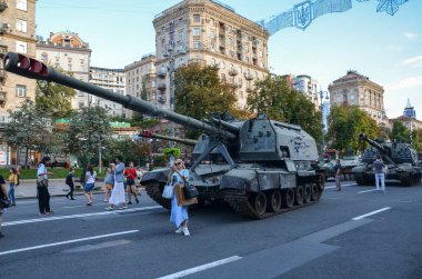 People visit an exhibition of destroyed Russian military vehicles and weapons, dedicated to the upcoming country's Independence Day 