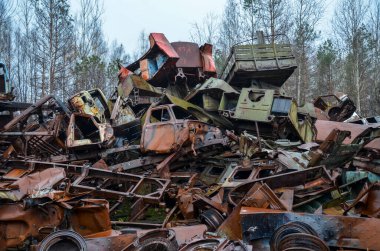 Bunch of old rotten rusty automobile abandoned in the woods. Car dump