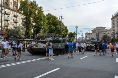 People inspect the damaged and captured military tank of the Russian occupying forces on Khreshchatyk Street in the center of Kyiv