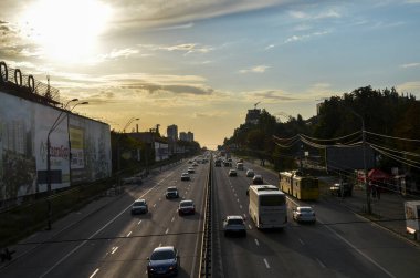 Busy multi-lane highway traffic in a big city in sunset. Rush Hour 