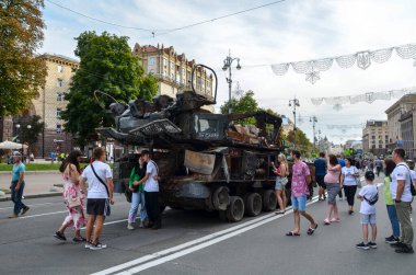 People visit an exhibition of destroyed Russian military vehicles and weapons in Kyiv