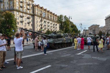 People walk on Kyiv central street Khreshchatyk during exhibition tanks, vehicles and other Russian military equipment destroyed by Ukrainian forces