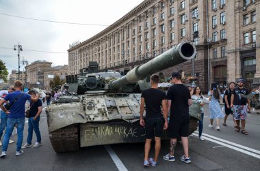 People walk on Kyiv central street Khreshchatyk during exhibition tanks, vehicles and other Russian military equipment destroyed by Ukrainian forces