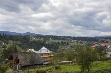 Yeşil çayır ormanı ve Vorokhta köyü, Ukrayna 'daki Karpat dağlarını çevreledi. Güzel doğa manzarasının manzarası