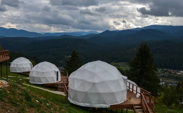 stock image Glamping (glamour camping) is a domed eco-hotel with an incredible view of the surrounding natural panoramas of forested mountains.Glamping is where stunning nature meets modern luxury