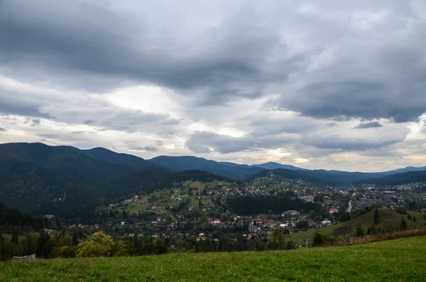 stock image Beautiful landscape from a height. Typical Carpathian village in a valley, forest and mountains under cloudy sky. Carpathians, Ukraine