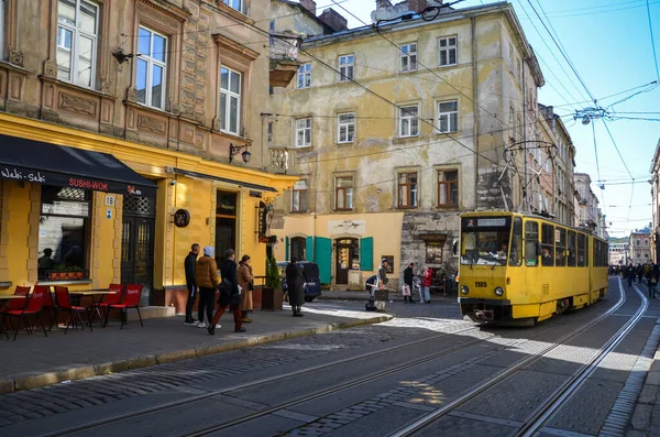 stock image Old yellow tram at cobbled narrow street historic city center of Lviv Ukraine