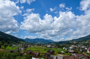 Dağların arasında yerel köy evleriyle kaplı yeşil geniş dağ vadisiyle güzel Karpatya manzarası. Verkhovyna, Ukrayna