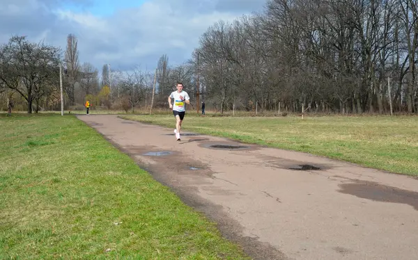 A person intentionally taking a different path on a hiking trail, with a sense of adventure