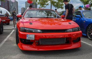 Red classic Japanese sports coupe Nissan Silvia 200SX S14 1995 in a car meet event in Kyiv clipart