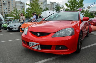 Red Acura RSX - maneuverable front-wheel-drive American alternative to a Honda Integra sports car presented at automobile festival Kyiv Car Fest  clipart