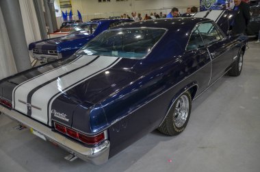 1966 Chevrolet Impala SS, klasik bir Amerikan kaslı arabasıdır. Tarzı ve gücü simgeler ve klasik araba koleksiyonunda göze çarpar.