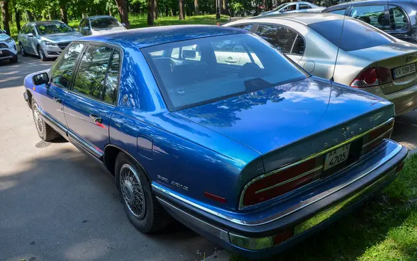 1991 Buick Park Bulvarı, Amerikan lüksü ve konforunu simgeleyen klasik bir tam boy sedan. Bu model parlak, açık safirli mavi metalik bir dış görünüme sahiptir.