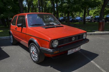Kırmızı 1980 Volkswagen Golf, klasik önden çekişli hatchback, kompakt tasarımı ve güvenilir performansı ile ünlüdür.