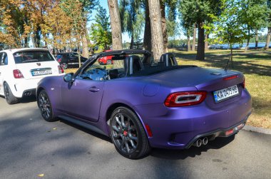 Stylish roadster convertible Abarth 124 Spider combines a turbocharged 1.4-liter engine with a sleek, retro-inspired design of Italian flair clipart