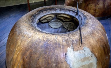 Traditional Armenian bread baking in a clay oven tonir, showcasing fresh flatbreads sticking to the interior walls clipart