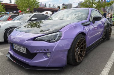 Modifiye spor araba mor Subaru BRZ açık hava araba etkinliği sırasında siyah kaput, geniş gövde kiti ve bronz tekerlekler