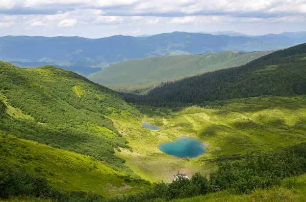 Bereketli yeşil vadi ve Vorozheska Gölü 'nün yuvarlanan tepeler arasında yer aldığı sakin bir dağ manzarası nefes kesici. Karpat Dağları, Ukrayna