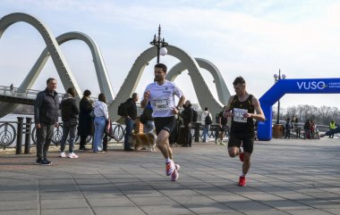 Seyircilerin tanık olduğu canlı koşu yarışında katılımcılar yarışıyor. Sahne, olayın enerjisini ve koşucuların nişanını yakalıyor.