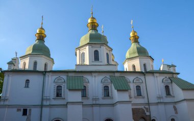 St. Sophia Katedrali 'nin yeşil ve altın kubbelerinin parlak mavi gökyüzünün altında dağınık bulutların altında görüntüsü. Kyiv, Ukrayna