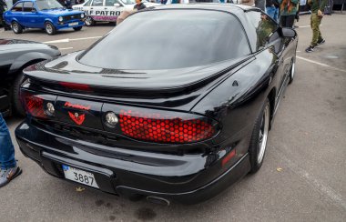 Siyah dördüncü nesil Pontiac Firebird Trans Am. Ani farları ve Ram Air kaputu kepçeleriyle agresif ön fasyası ile tanımlanabilir.