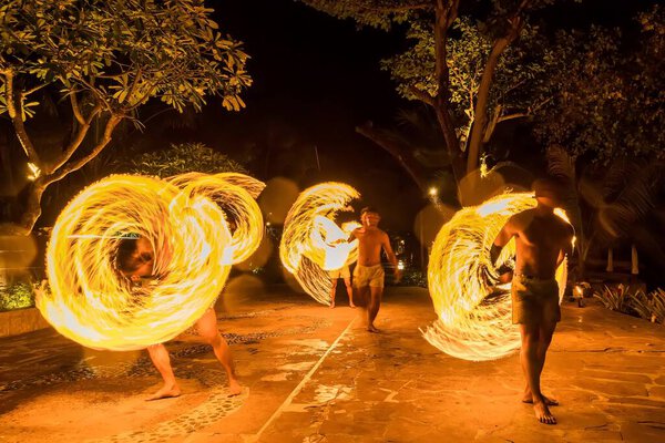 Bangkok, Thailand - October, 15, 2022 : Unidentified name Actors perform fire swinging at dusk in a restaurant on Koh Samet in Thailand.